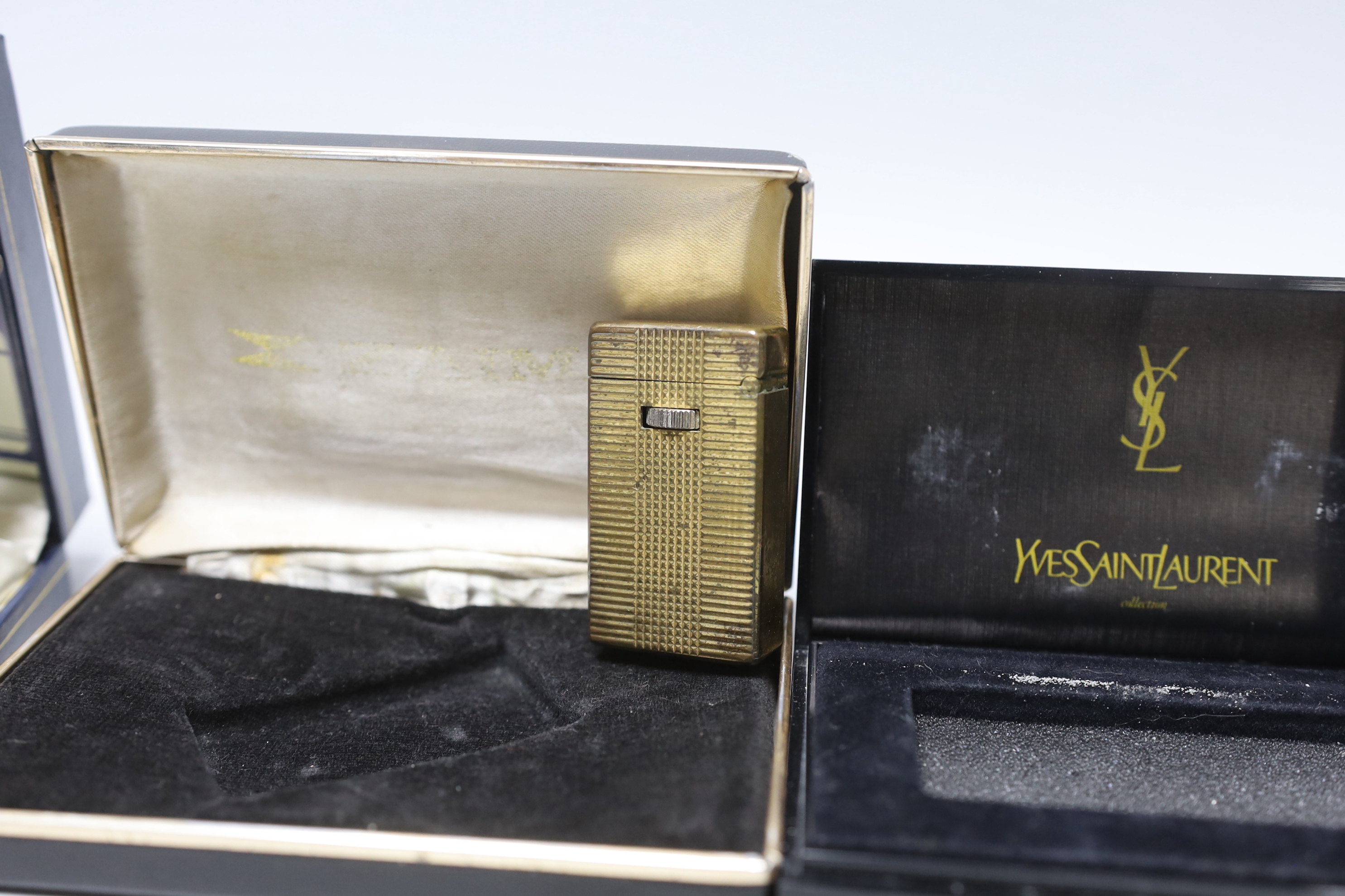 An Yves Saint Laurent lighter and three others, boxed